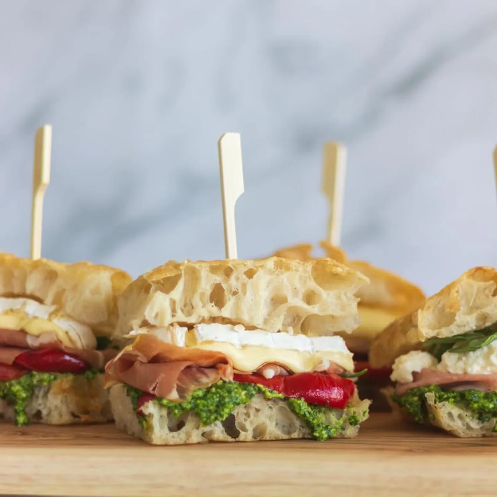 Gourmet focaccia sandwiches filled with deli ingredients