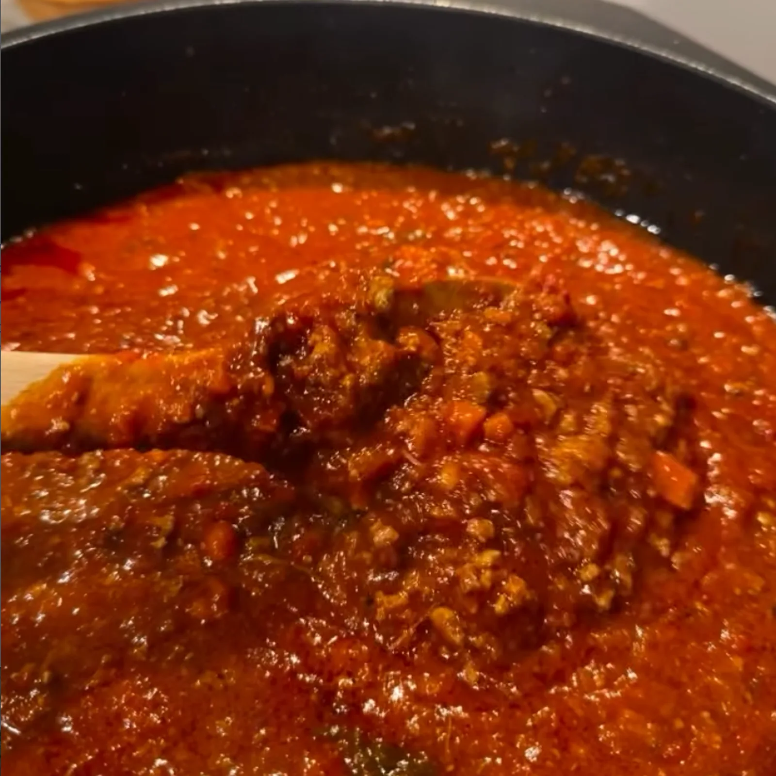 Tomato sauce being prepared by hand